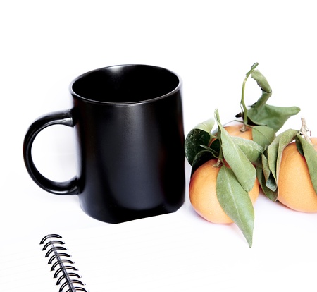 background with tangerines, notebook and cupの写真素材