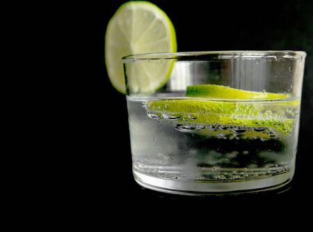  tonic with lime fruits isolated in black backgroundの写真素材