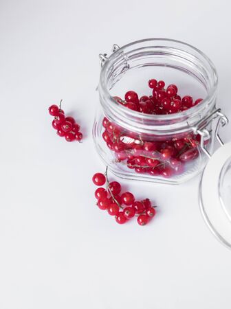 Red berries in glass bowl on whiteの写真素材