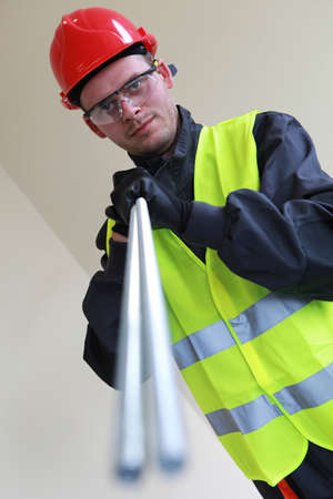 Young Happy Carpenter Holding Building Materials