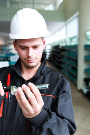 Craftsman holding a screwの写真素材