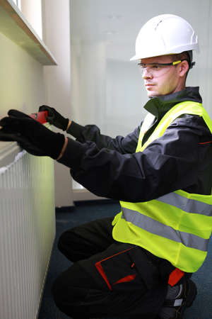 Worker using level on building siteの写真素材