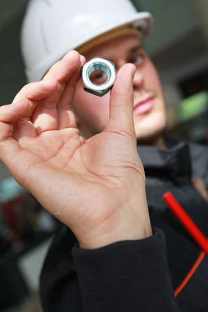 Craftsman holding a screwの写真素材