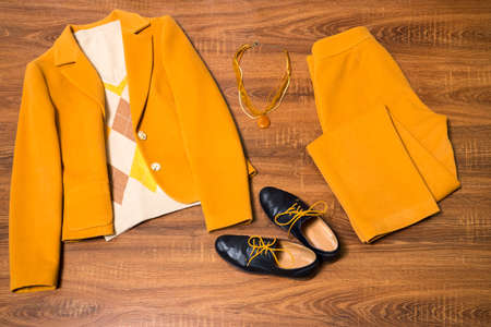 Set of stylish female clothes and accessories on wooden backgroundの写真素材