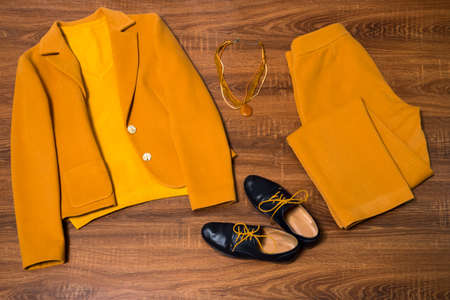 Set of stylish female clothes and accessories on wooden backgroundの写真素材