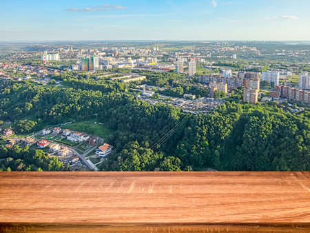 Empty wooden table with blurred background of aerial view of the the Nizhny Novgorod city. Can be used for display or montage productsの写真素材