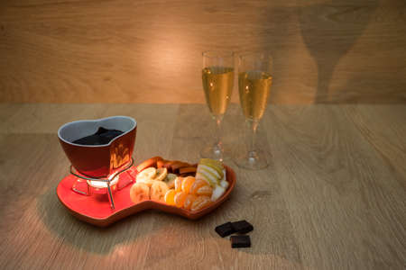 Chocolate fondue with fruit and champagneの写真素材