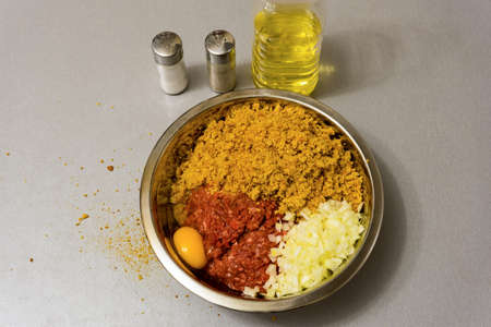 Ingredients for cooking meatballs: minced meat, breadcrumbs, milk, egg, onion, oil, salt, ground pepperの写真素材