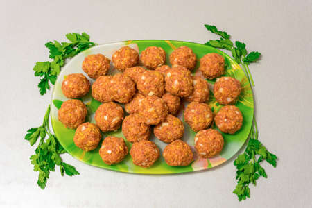 Raw meatballs on a platterの写真素材