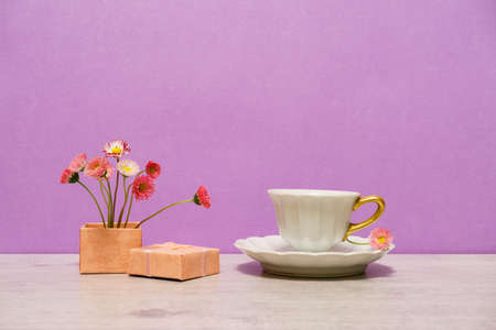 Summer creative still life in minimal style. Pink Marguerite daisy flowers bouquet in little gift...