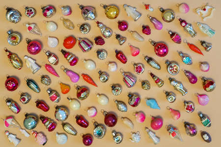 Many colorful new year toys lying on color background, top view, flat lay. Creative Christmas...