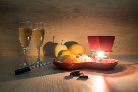 Chocolate fondue with fruit and champagne. Romantic dinner. Love, romance or Valentine's day conceptの写真素材