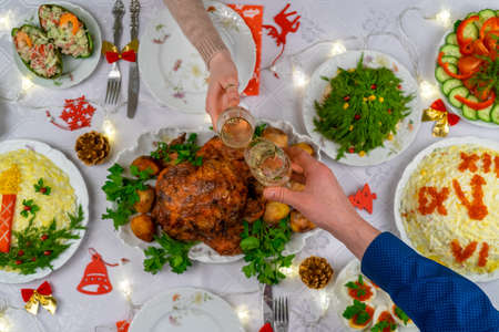 Human hands holding glasses with sparkling wine. Friends or family toasting with champagne over...