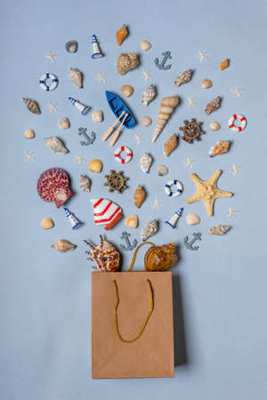 Various decorative nautical items, seashells, sea stars and miniature toys flying from kraft paper...