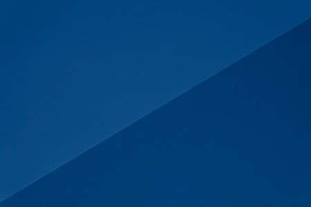 Color of the year 2020 classic blue. Texture of classic blue double tone paper for watercolor divided diagonally. Modern luxury background, mock up, copy space. Fashion pantone color trend concept.の写真素材