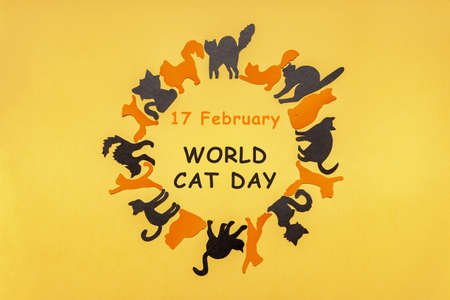 Happy International Cat Day in Europe. Round frame made of orange and black cat silhouettes on...