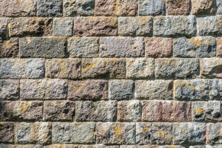 Stone brickwork texture of old ancient wall in sunny day. Modern luxury background for design with...