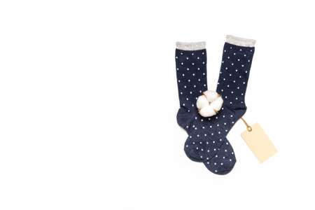 Pair of modern trendy women's cotton polka dot socks with cotton flower and price tag on white background. fashionable socks store. Socks shopping, sale, merchandise, advertisement concept.の写真素材