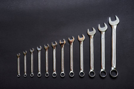 Set of wrenches on black background. Tools spanners. Technique repair, equipment for mechanical service, labor or father's day concept. Flat lay, top view, copy space.の写真素材