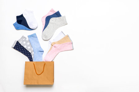 Various modern trendy women's cotton socks set in shopping bag on white background. fashionable socks store. Socks shopping, sale, merchandise, advertisement concept.の写真素材