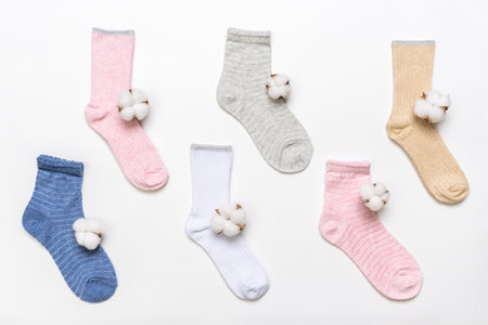 Various modern trendy women's cotton socks set with cotton flowers on white background. fashionable socks store. Socks shopping, sale, merchandise, advertisement concept. Flat lay, top view.の写真素材
