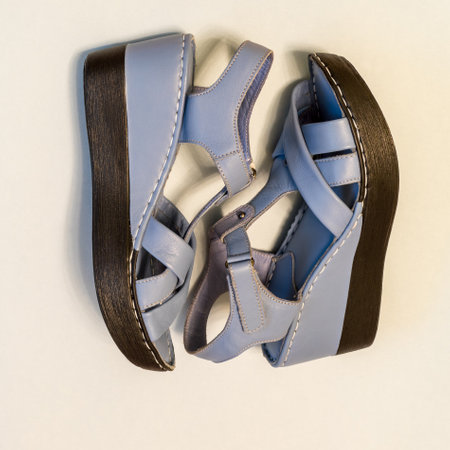 Blue sandals on light background. Stylish summer women's leather shoes, top view.の写真素材
