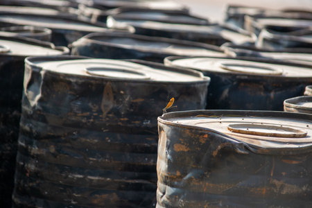 Close up of oil barrels in a row. Selective focus.