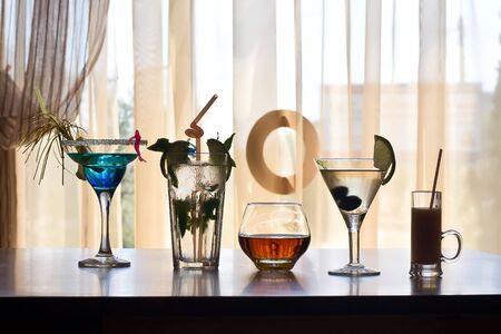 Alcoholic drinks in glasses worth in a lineの写真素材