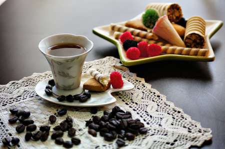 Cup of coffee with sweet cream puff and another sweets の写真素材