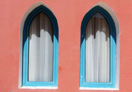 Arabic architecture: windows and bright coral wall         の写真素材