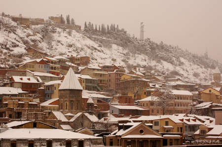 Winter view to covered with snow Tbilisi Old town in misty day