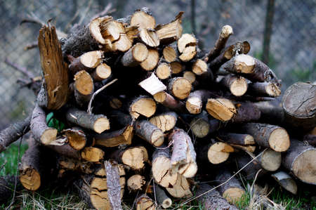 Background of dry chopped firewood logs stacked up on top of each other in a pileの写真素材