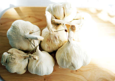 Closeup of garlic heads on the wooden desk
