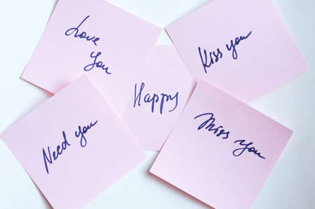 Stick paper with letters on white backgroundの写真素材