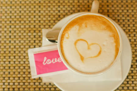 Cup of cappuccino with heart signの写真素材
