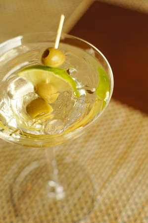 Glass of martini with lemon and oliveの写真素材