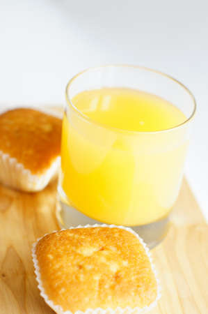 Healthy breakfast: fresh orange juice and cupcakeの写真素材