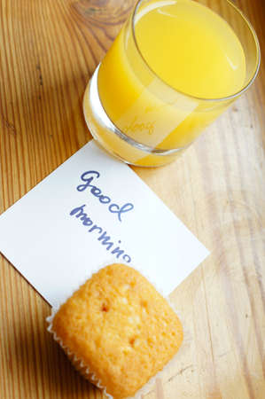 Healthy breakfast: fresh orange juice and cupcakeの写真素材