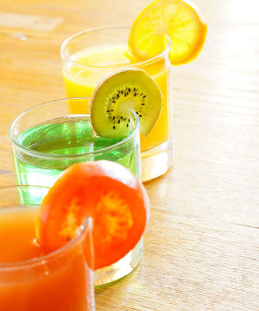 Healthy breakfasr: closeup of kiwi, orange and tomato juice and fruitsの写真素材