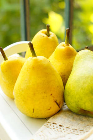 Natural pear juice in a glass bottle and fresh pears on the tableの写真素材