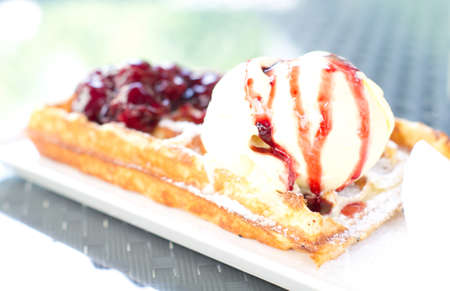 Ice cream with cherry and french waffleの写真素材