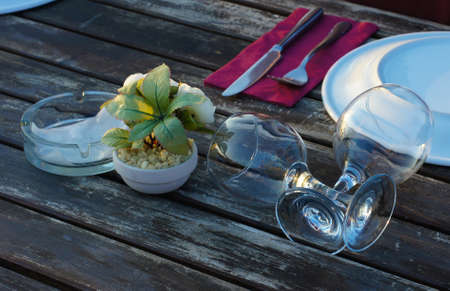 Outdoor wooden table setting is ready for dinnerの写真素材