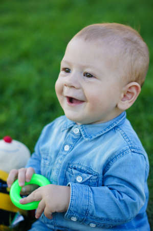 Baby boy is playning on the green grassの写真素材