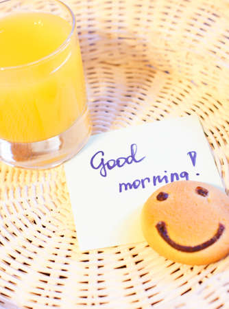 Healthy breakfast: fresh orange juice and smile cakeの写真素材