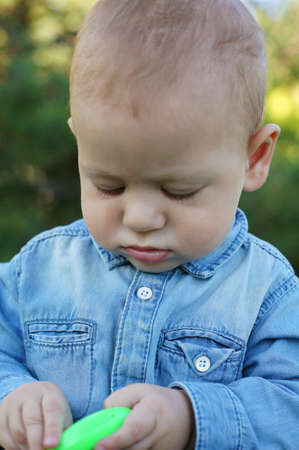 Baby boy is playning on the green grassの写真素材