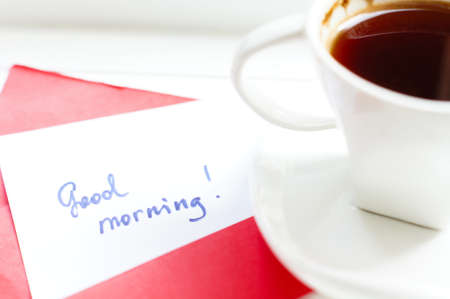 Morning time: cup of coffee and Good morning greeting cardの写真素材