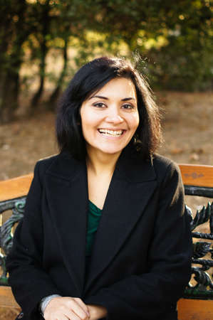 Beautiful eastern woman in autumnal park
