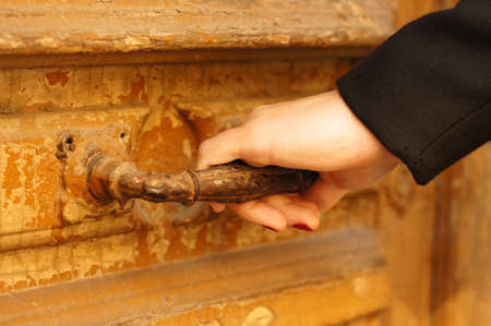 Old door lock and woman handの写真素材