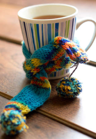 Winter time: cup of hot tea with lemon and scarfの写真素材