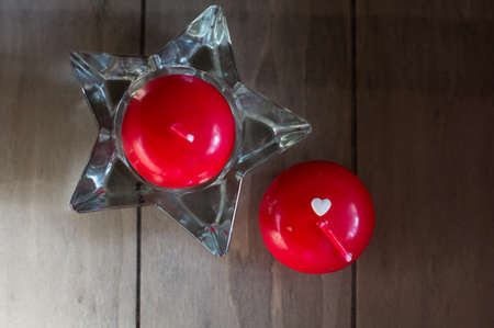 Red candles and white hearts on the wooden deskの写真素材